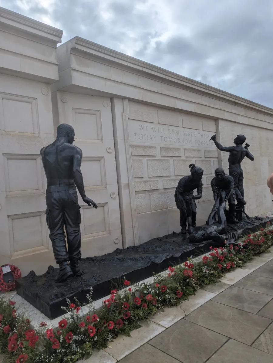 The bronze sculptures at the Armed Forces Memorial, with the inscription We will remember them, today, tomorrow, forever, and poppies along the base