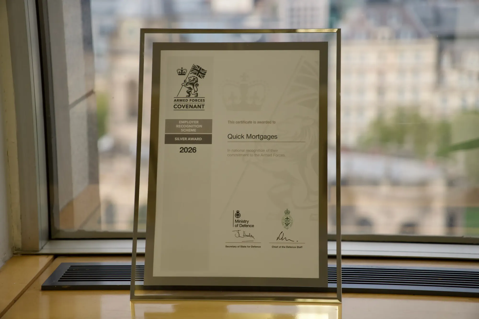 Our Armed Forces Covenant Employer Recognition Scheme Silver Award 2026 certificate, framed on the office windowsill